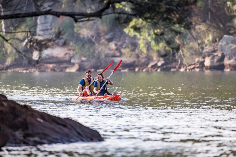 Two kayakers paddle toward the camera