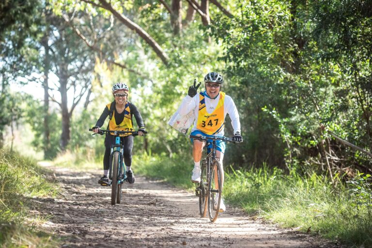 two teammates mountain bike ride together looking for checkpoints